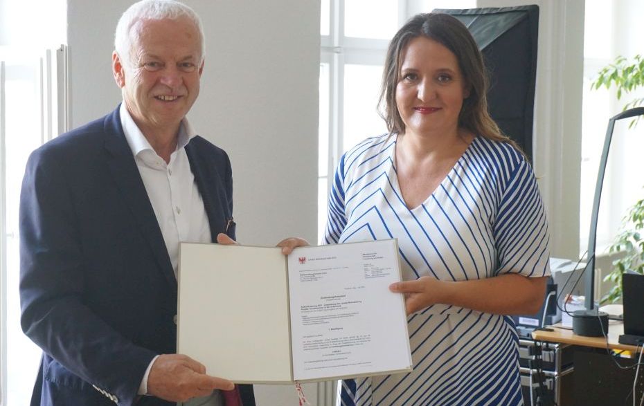 Foto: Schüle und Polzehl mit der Bescheid-Mappe