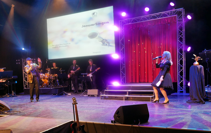 Foto: Sängerin und Sänger mit Band auf der Bühne